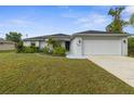 Charming single-story home featuring a well-manicured lawn and an attached two-car garage at 2665 Chipley Ave, North Port, FL 34286