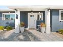Inviting front porch with stylish lighting and a freshly paved walkway at 303 Bryn Mawr Is, Bradenton, FL 34207