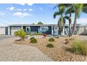 Charming single-story home with a well-maintained gravel yard and lush landscaping at 303 Bryn Mawr Is, Bradenton, FL 34207