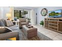 Cozy living room featuring stylish furnishings, a large window with view, and neutral decor at 323 Timberlake Dr # 323, Bradenton, FL 34210