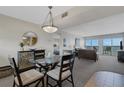 Bright and airy living room featuring a dining area and balcony access with ocean views at 3235 Gulf Of Mexico Dr # A305, Longboat Key, FL 34228