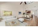 Bright living room with modern decor, high ceilings, and an open-concept layout connecting to the kitchen at 3664 Course Dr, Sarasota, FL 34232