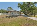 Charming home featuring a well-maintained lawn, concrete driveway, and partial white fence surrounding the property at 3862 Lothair Ave, North Port, FL 34287