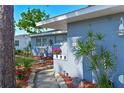 The home's exterior features a quaint walkway, a chair set, and tasteful landscaping at 404 62Nd Nw St, Bradenton, FL 34209