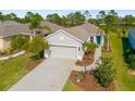 Aerial view of a well-landscaped home, driveway, and front yard at 4162 Deep Creek Ter, Parrish, FL 34219