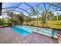 Screened-in pool with a spa and landscaped backyard at 4162 Deep Creek Ter, Parrish, FL 34219