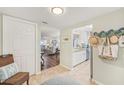Bright foyer leading to the living room and kitchen, showcasing the open floor plan and stylish decor at 5647 Sheffield Greene Cir # 29, Sarasota, FL 34235