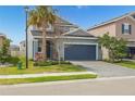 Charming two-story home featuring a well-manicured lawn and an attached two-car garage at 5759 Bungalow Grove Ct, Palmetto, FL 34221
