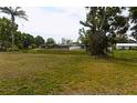 Expansive backyard with lush greenery and a serene waterfront view, perfect for outdoor enjoyment at 6309 35Th W Ave, Bradenton, FL 34209