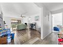 Open living space with wood floors, neutral walls, and natural light from large windows with a ceiling fan at 6348 7Th W Ave # 6348, Bradenton, FL 34209