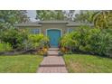 Beautiful home with vibrant blue door and a meticulously maintained front garden at 640 N Osprey Ave, Sarasota, FL 34236