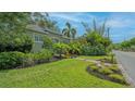 Inviting home featuring lush landscaping, well manicured lawn, and a lovely sidewalk at 640 N Osprey Ave, Sarasota, FL 34236