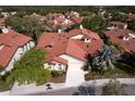 Aerial view showcasing the home's roof, driveway, landscaping, and neighborhood at 7340 Villa D Este Drive, Sarasota, FL 34238