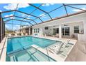 A screened pool with a hot tub, outdoor lounge area and a beautiful view at 8163 Redonda Loop, Lakewood Ranch, FL 34202