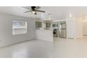 Open-concept kitchen and living room with modern stainless appliances and ample natural light at 842 31St E Ave, Bradenton, FL 34208