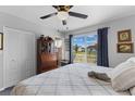 Bright bedroom featuring a comfortable bed, large window, and traditional furnishings at 8718 Gaillard Ave, North Port, FL 34287