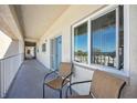 Building hallway showing covered walkway and seating outside the residence's front door at 1650 1St W Ave # 503B, Bradenton, FL 34205
