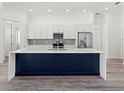Modern kitchen featuring a large island, stainless steel appliances, and sleek cabinetry at Lot 20 Garafola Ave, North Port, FL 34291
