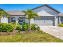 Charming single-story home featuring a well-manicured front yard and a two-car garage at 10519 Spring Tide Way, Parrish, FL 34219