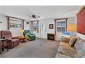Cozy living room with large windows and an electric fireplace insert at 1212 41St Avenue E Dr, Ellenton, FL 34222