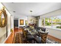 Elegant dining room with a glass-top table, designer chairs, and a large window at 1538 S Orange Ave, Sarasota, FL 34239