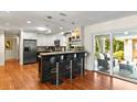 Open kitchen with bar seating, stainless steel appliances, and a sliding door to the outdoor patio at 1538 S Orange Ave, Sarasota, FL 34239