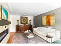Modern living room with stylish decor, fireplace, flat screen TV, and sleek white sofa at 1538 S Orange Ave, Sarasota, FL 34239