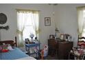 Cozy bedroom featuring a twin bed, vintage decor, and natural light streaming through the window at 1711 30Th W St, Bradenton, FL 34205