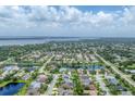A panoramic aerial view showcases the residential neighborhood surrounded by lush greenery and serene lakes at 1727 88Th Nw Ct, Bradenton, FL 34209
