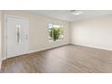 Inviting living room with wood flooring, natural light, and a freshly painted interior at 2070 Carpetgreen St, Port Charlotte, FL 33948
