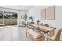Bright and airy living area with dining space, modern furnishings, and sliding glass doors at 2457 Mellow Ln, Clearwater, FL 33765