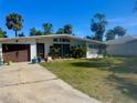 Charming one-story home with attached garage, manicured lawn, and a paved driveway at 2707 52Nd Avenue W Ter, Bradenton, FL 34207