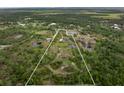 Expansive acreage showcasing a private estate with multiple ponds and lush landscaping at 30416 Saddlebag Trl, Myakka City, FL 34251