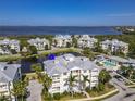 Inviting aerial view of stunning condo buildings with a pool and a peaceful pond at 3420 77Th W St # 202, Bradenton, FL 34209