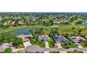 Beautiful aerial view of a home with a pool, lush green golf course, scenic ponds, and stunning residential community at 3725 Spyglass Hill Rd, Sarasota, FL 34238