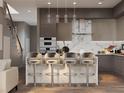 Modern kitchen features a waterfall island, stainless appliances, and pendant lighting at 3811 30Th S Ave, St Petersburg, FL 33711