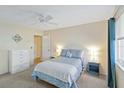 Cozy bedroom featuring a ceiling fan and a blue bed set with matching curtains at 3917 Ashwood Ln # 57, Sarasota, FL 34232