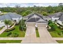 Aerial view of a one-story home with well-maintained landscaping and a two car garage at 4021 Wildgrass Pl, Parrish, FL 34219