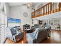 Spacious living room with high ceilings, hardwood floors, and a loft area, offering a comfortable and stylish living space at 4063 Woodview Dr, Sarasota, FL 34232