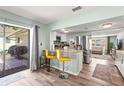 Open kitchen featuring a breakfast bar with seating, stainless steel appliances, and sliding door to the deck at 4311 2Nd E Ave, Bradenton, FL 34208