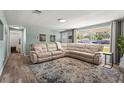 Inviting living room with a comfortable sectional sofa, a large window, and wood-look flooring at 4311 2Nd E Ave, Bradenton, FL 34208