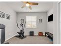 A bright exercise room features an elliptical machine, bench, ceiling fan, and natural lighting at 4406 Baltry Ct, Bradenton, FL 34211