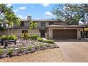 Charming home featuring mature trees and lush landscaping for enhanced curb appeal at 4711 Ocean Blvd, Sarasota, FL 34242