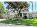 Well-maintained home with mature landscaping, featuring a three-car garage and decorative brick accents at 5151 Jasmine Way, Palm Harbor, FL 34685