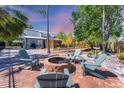 Enjoy a fire pit and relaxing Adirondack chairs in the home's backyard with screened in pool at 5404 4Th Avenue Nw Dr, Bradenton, FL 34209