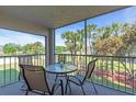 Outdoor balcony with seating overlooking verdant landscaped grounds and a tranquil pond at 6501 Stone River Rd # 209, Bradenton, FL 34203