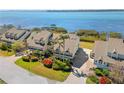 Aerial view of waterfront townhome with lush landscaping, brick paver driveway, and stunning ocean views at 71 Tidy Island Blvd, Bradenton, FL 34210