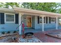 A charming single-story home with a covered entryway and brick path at 826 Lillian Ln, Sarasota, FL 34243