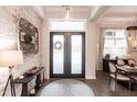 Elegant entryway with dark wood floors, shiplap accent wall, and modern light fixture at 1007 143Rd Ne St, Bradenton, FL 34212