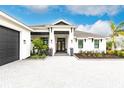 Beautiful home featuring a manicured lawn, covered front porch, and elegant exterior lighting at 1007 143Rd Ne St, Bradenton, FL 34212